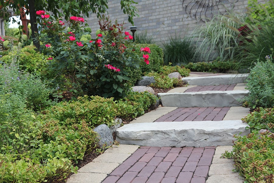 brick walkway surrounded by fresh landscaping