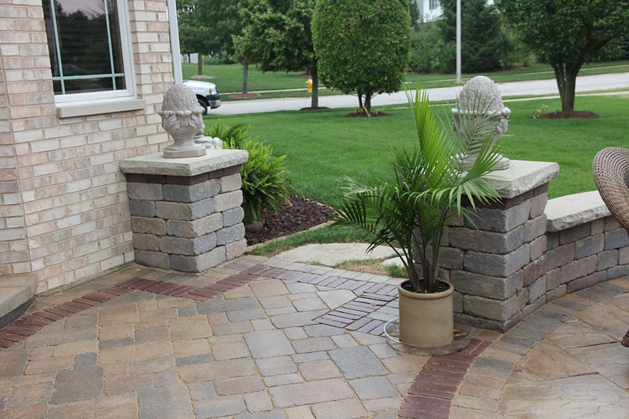 brick patio and retaining wall seating with brick pillars