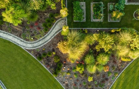 aerial shot of of cut grass with freshly laid mulch with plants