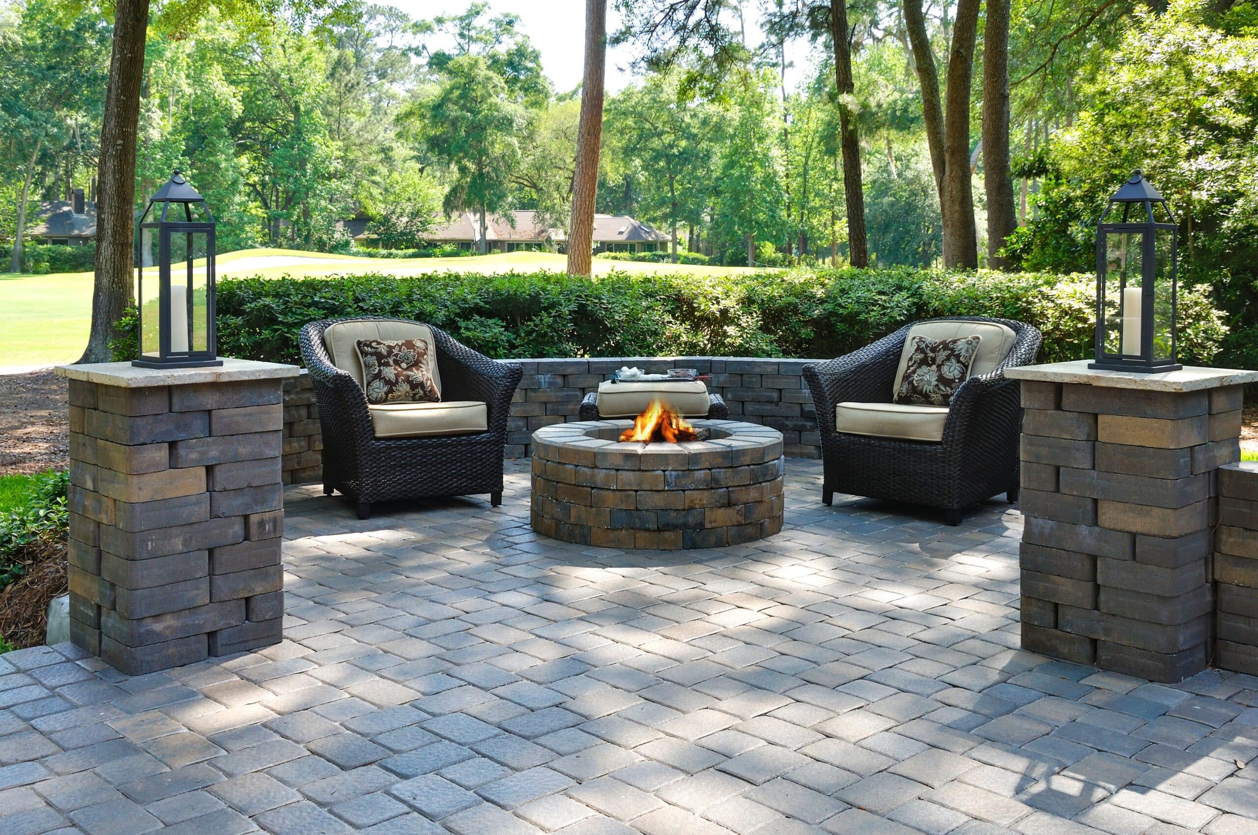 brick paver patio with brick pillars with outdoor lighting fixtures and brick fireplace in DuPage County, Naperville Illinois. Hardscaping done by bret-mar landscaping