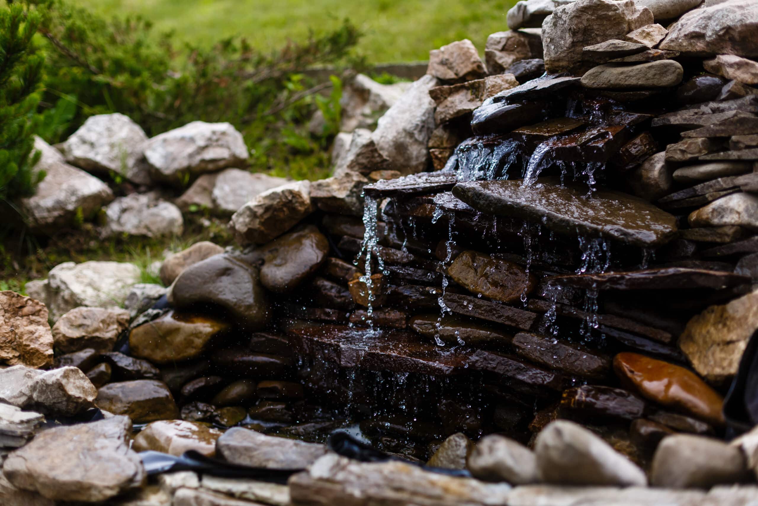 rock waterfall into pond. water features