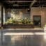 a sleek urban showroom showcases a variety of customizable metal border designs, each elegantly displayed against a modern backdrop of polished concrete and dramatic lighting, emphasizing their unique appeal for landscaping projects.