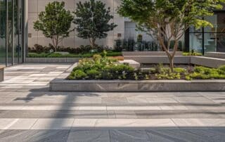 a sleek, contemporary urban plaza showcases essential modern hardscape design principles, featuring bold geometric patterns in stone paving and minimalist seating arrangements under striking architectural elements.