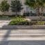 a sleek, contemporary urban plaza showcases essential modern hardscape design principles, featuring bold geometric patterns in stone paving and minimalist seating arrangements under striking architectural elements.